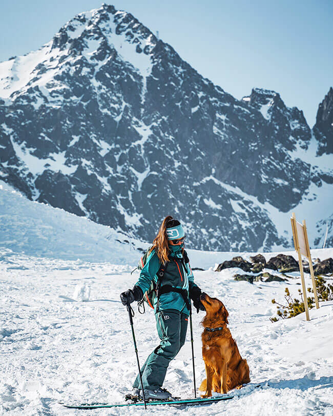 Skier with a dog in the High Tatras