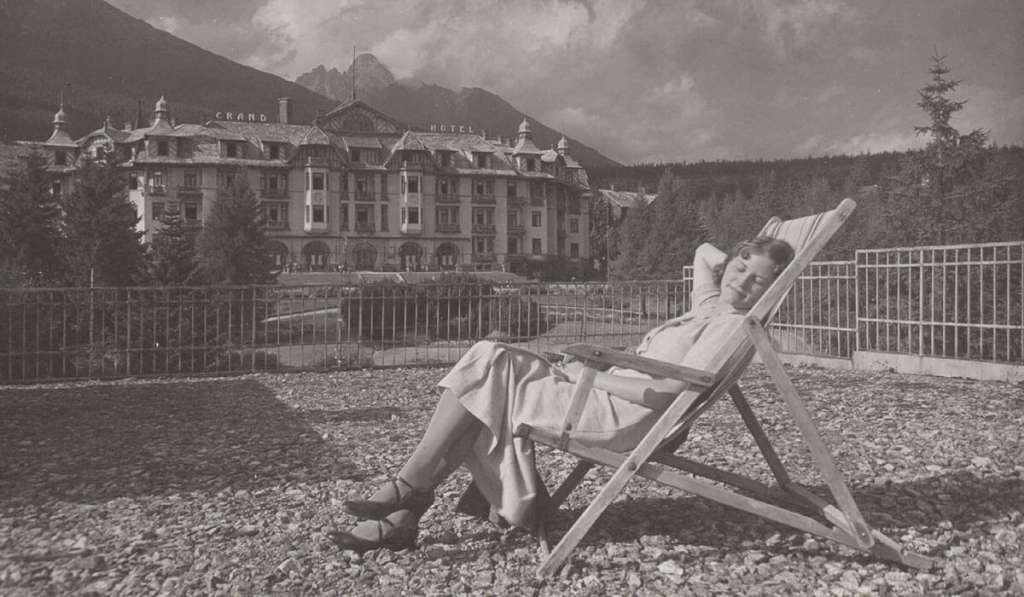 Woman lounging outside Grandhotel Starý Smokovec