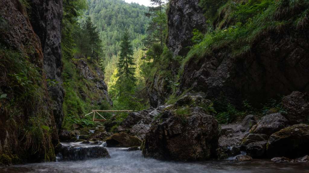 A view of Prosiecka Valley in the Choč Mountains with a small bridge over the river