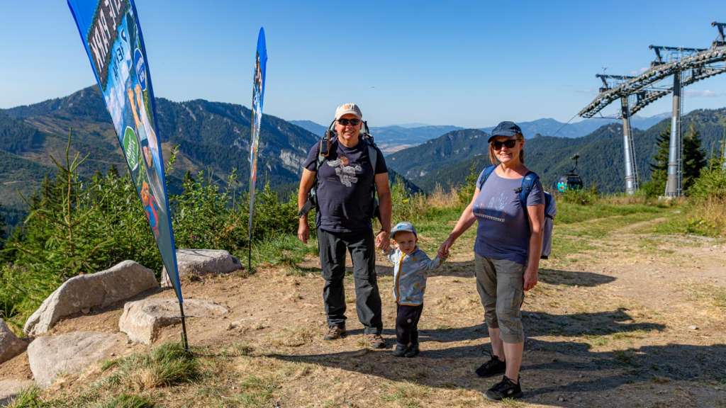Happy family with grandparents and their grandson posing at Slide Park Jasná