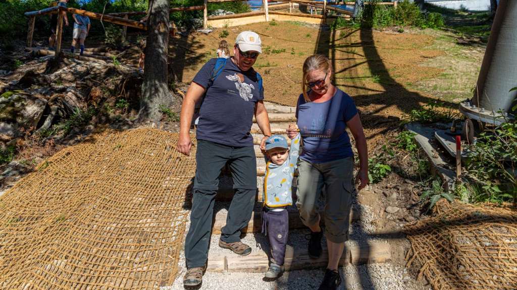 Family carefully walking down wooden steps