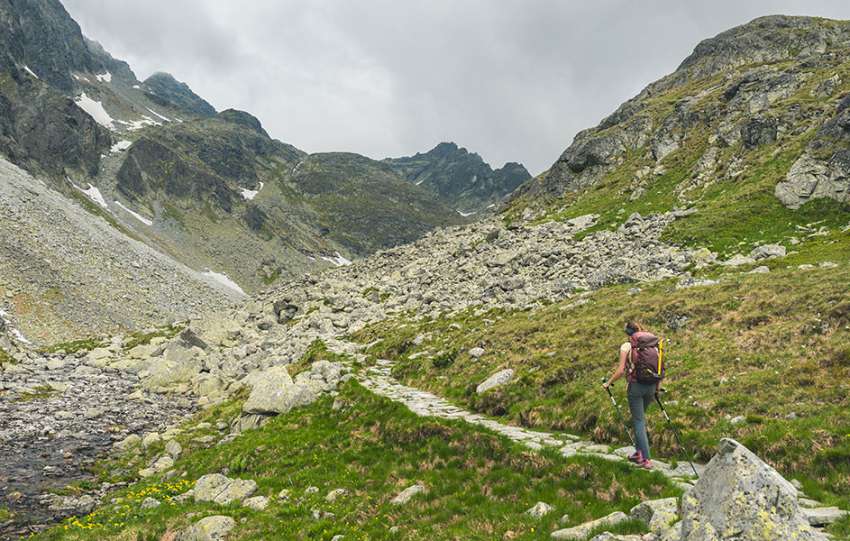 The mountains in Východná Vysoká and a hiker on a footpath